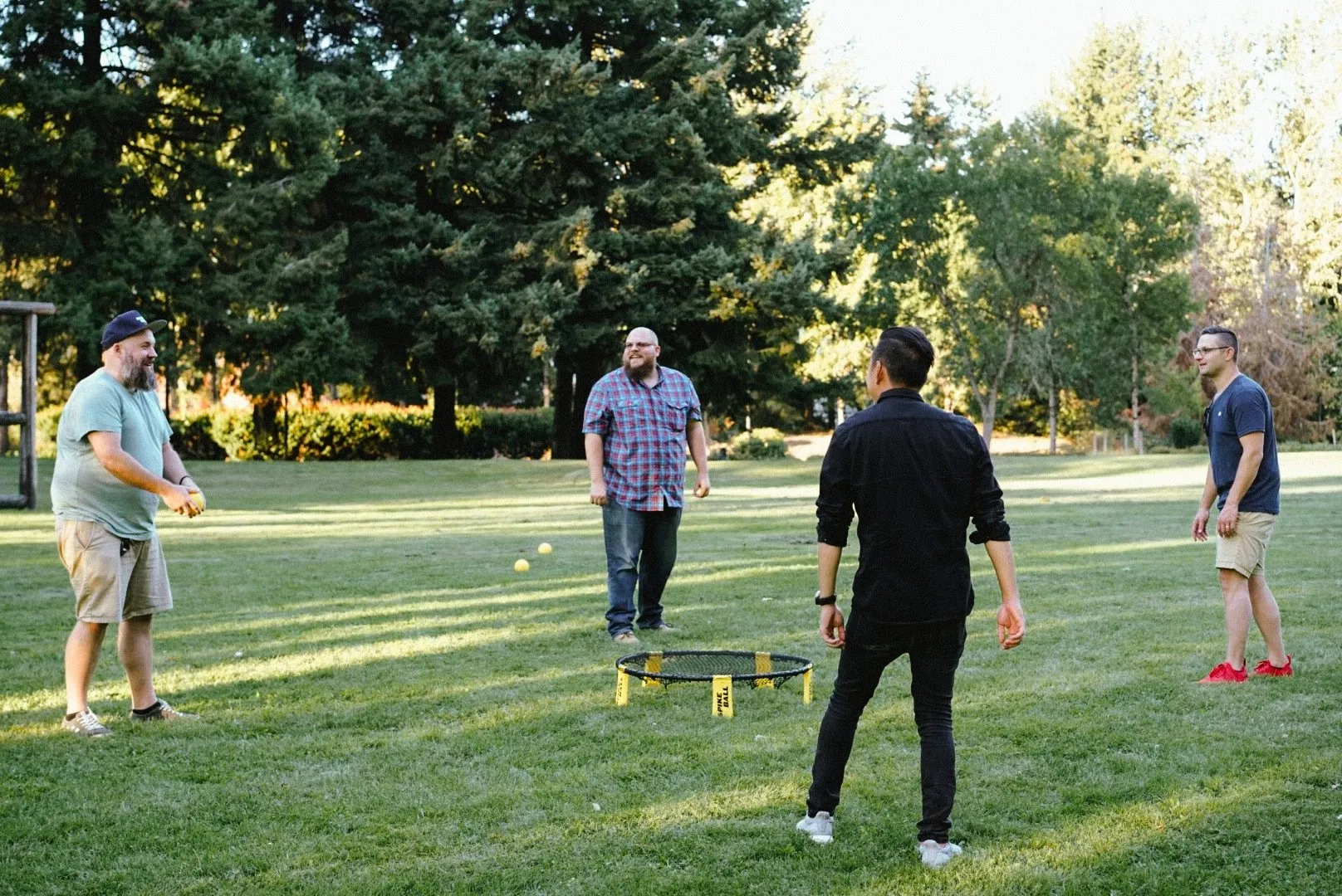 People having fun in a summer evening playing spikeball